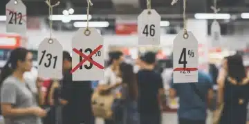 Retail price tags demonstrating anchoring bias with a diverse group of shoppers in a modern store.